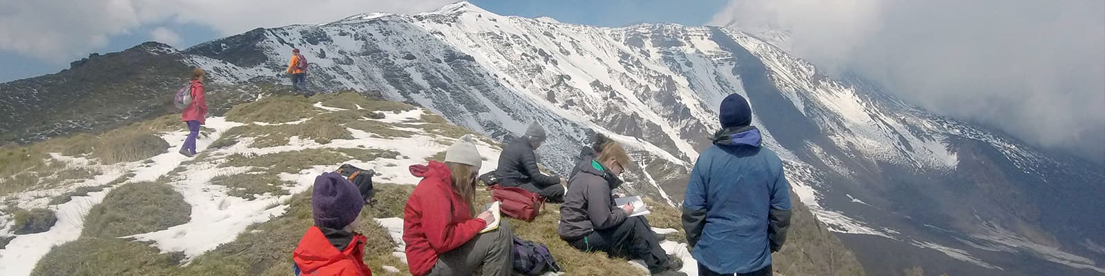 Students on the rim of Mount Etna's crater