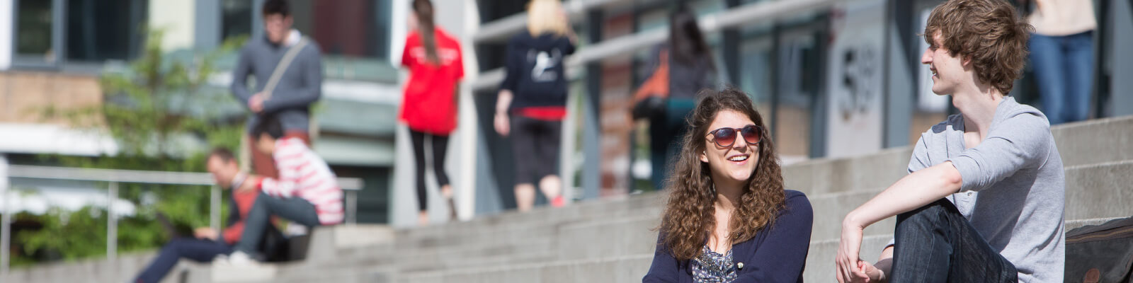 A group of students sat on Alex Square steps