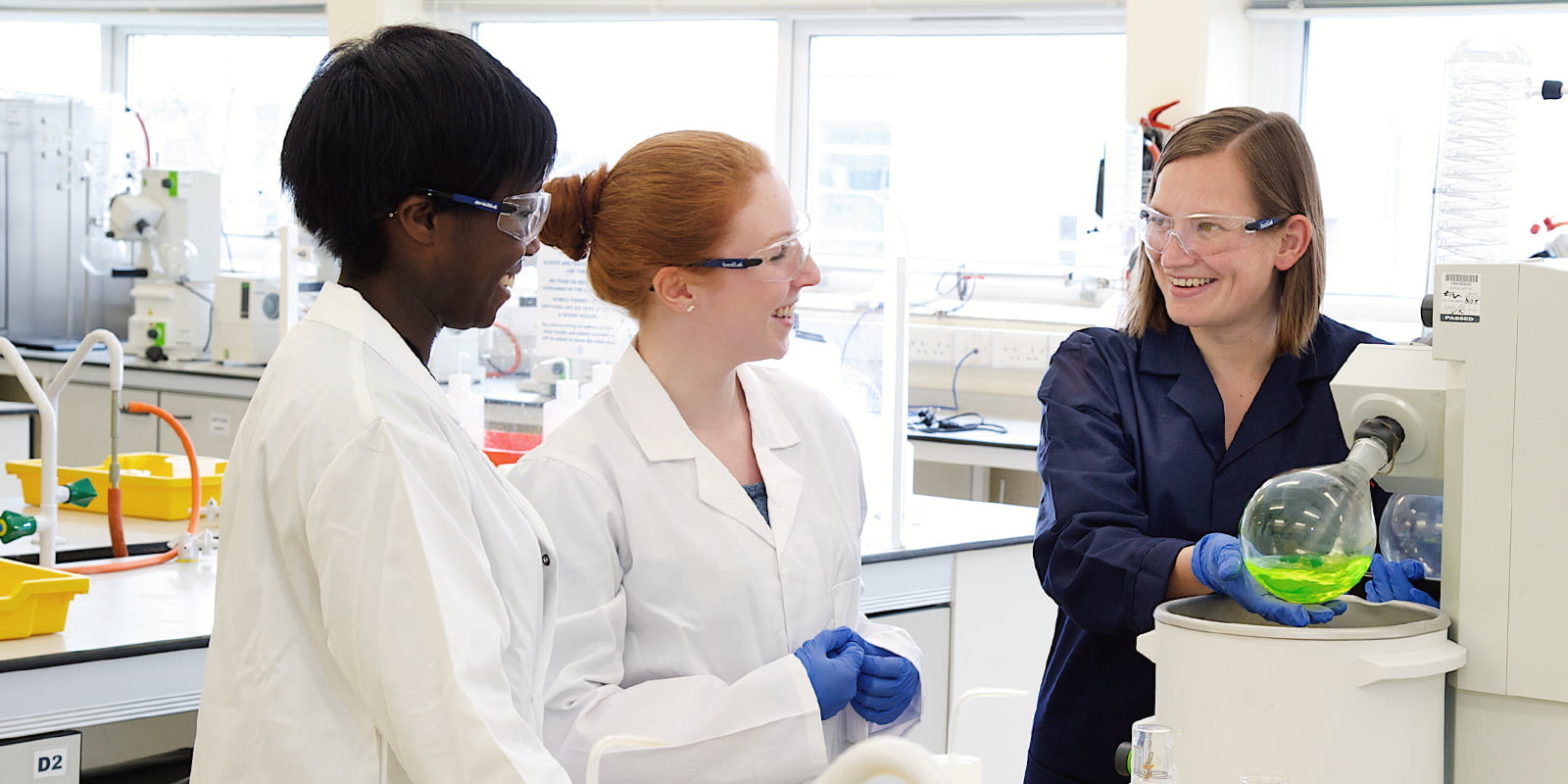 Two students and a lecturer in a Chemistry laboratory