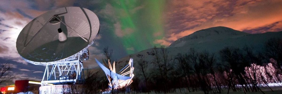 A ground-based satellite with the aurora in the background