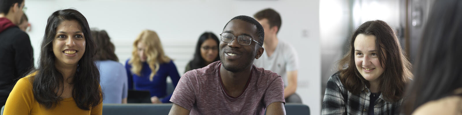 Students socialising with one another on the sofas in the Chemistry building foyer