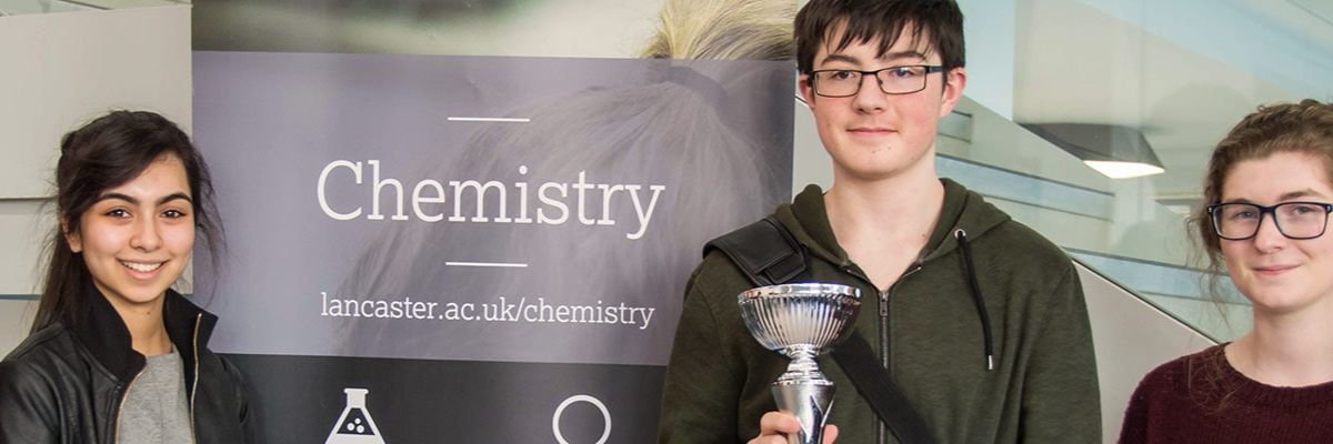 Students holding a trophy