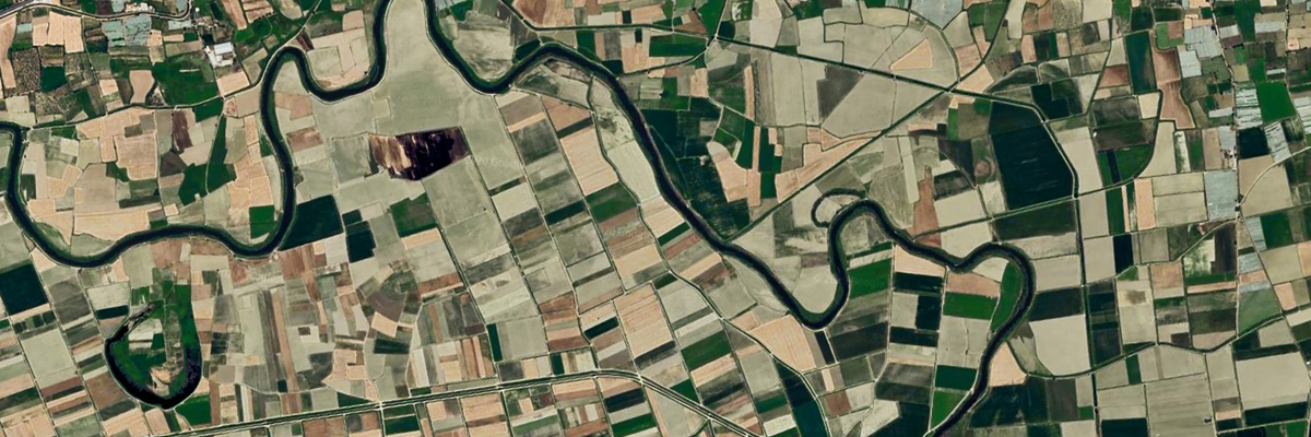 A satellite image of fields and a river