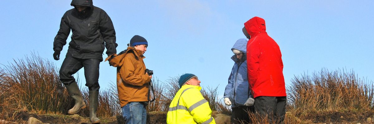 People conducting measurements in the field