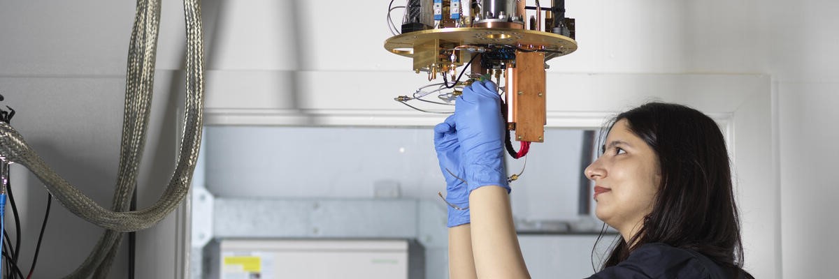 A PhD student examining a ULT Fridge