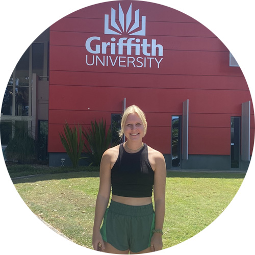 Holly in front of Griffith University sign in Australia