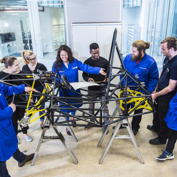 Engineering students stood around the Formula Student car