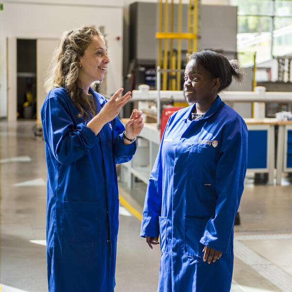Two girls stood talking in the Engineering lab