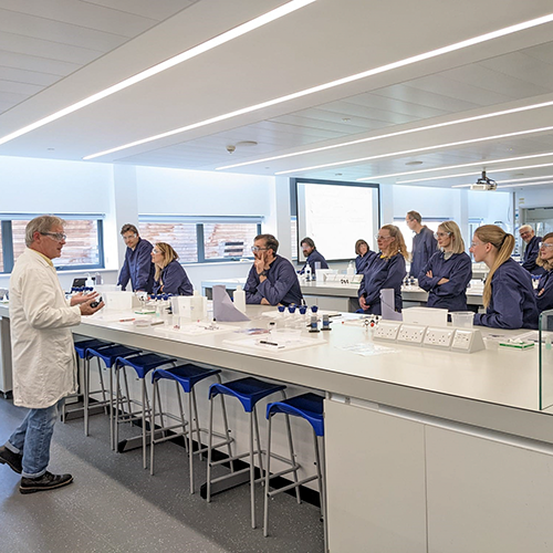 School teachers listening to a lecturer in a chemistry lab