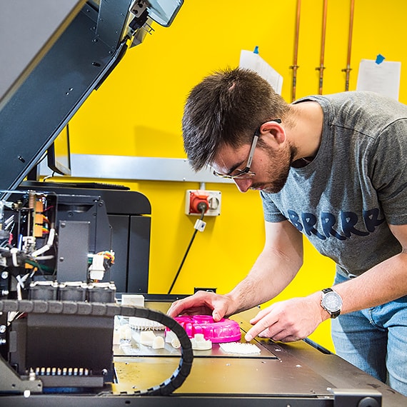 A student using a 3D printer