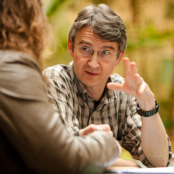 A lecturer in conversation with a student