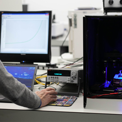 An academic testing a solar cell
