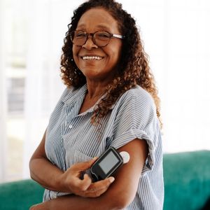 A woman with a glucose monitor in her arm