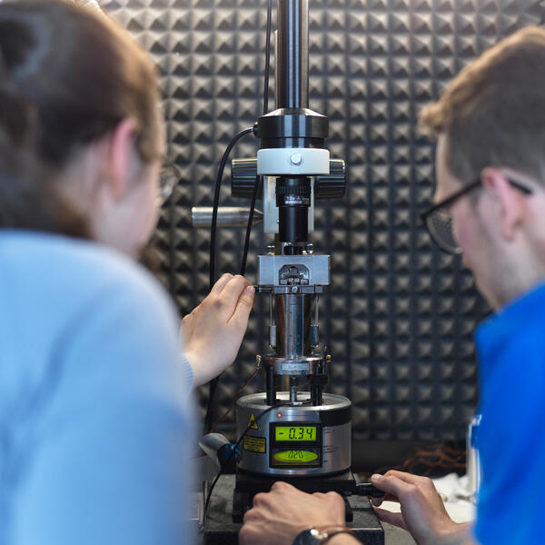 Two academics looking at the Scanning Probe Microscope