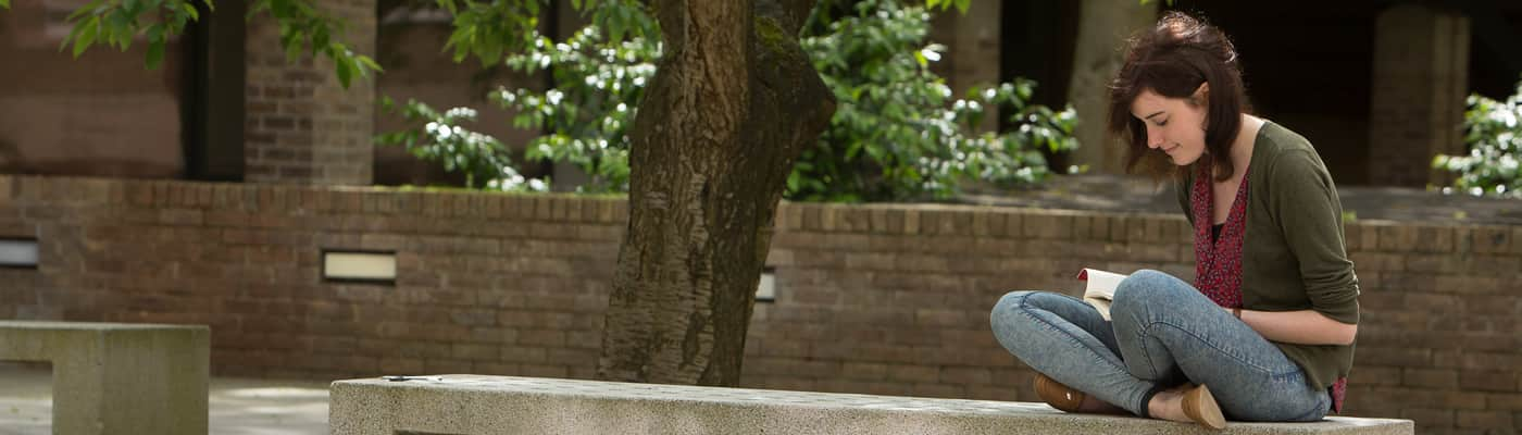 Student sitting on a bench