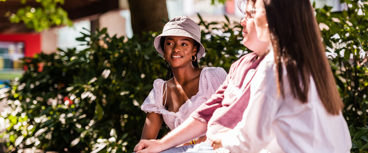 Student sits in the square in summer 