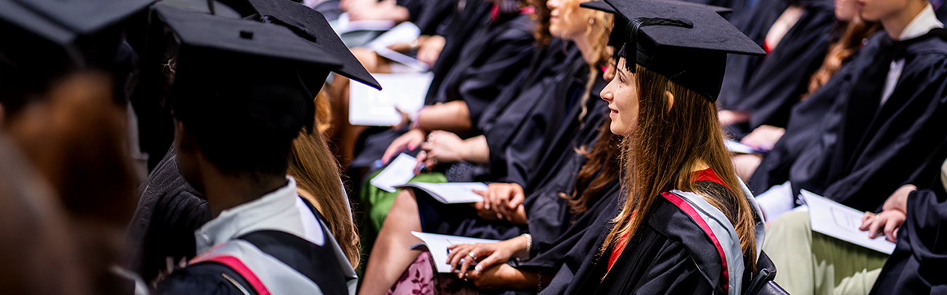 Students at graduation in caps and gowns 