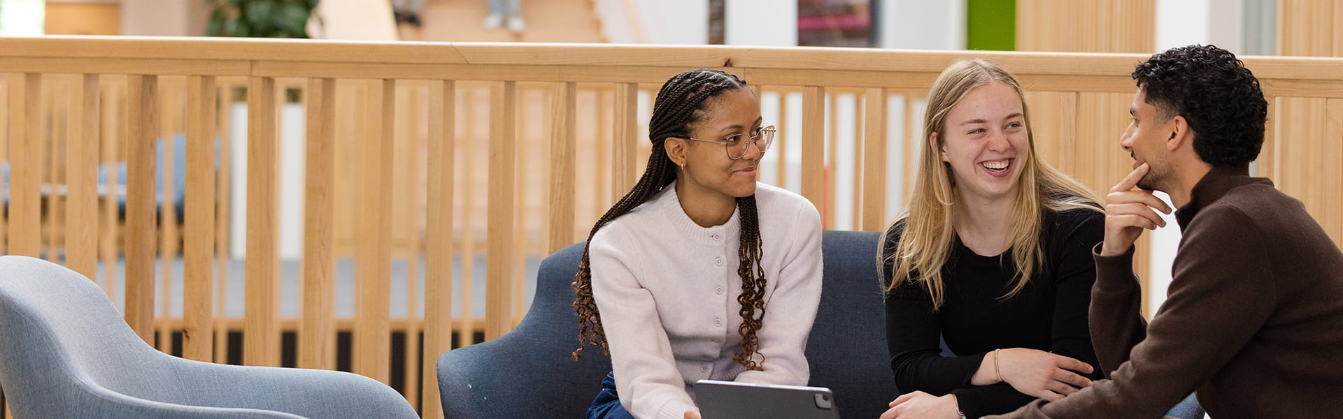 Students working together at a table in a bright, airy building