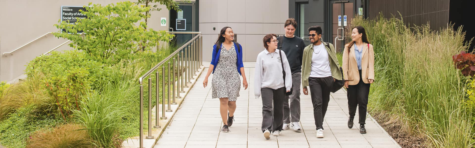 Students walking on campus on a sunny day