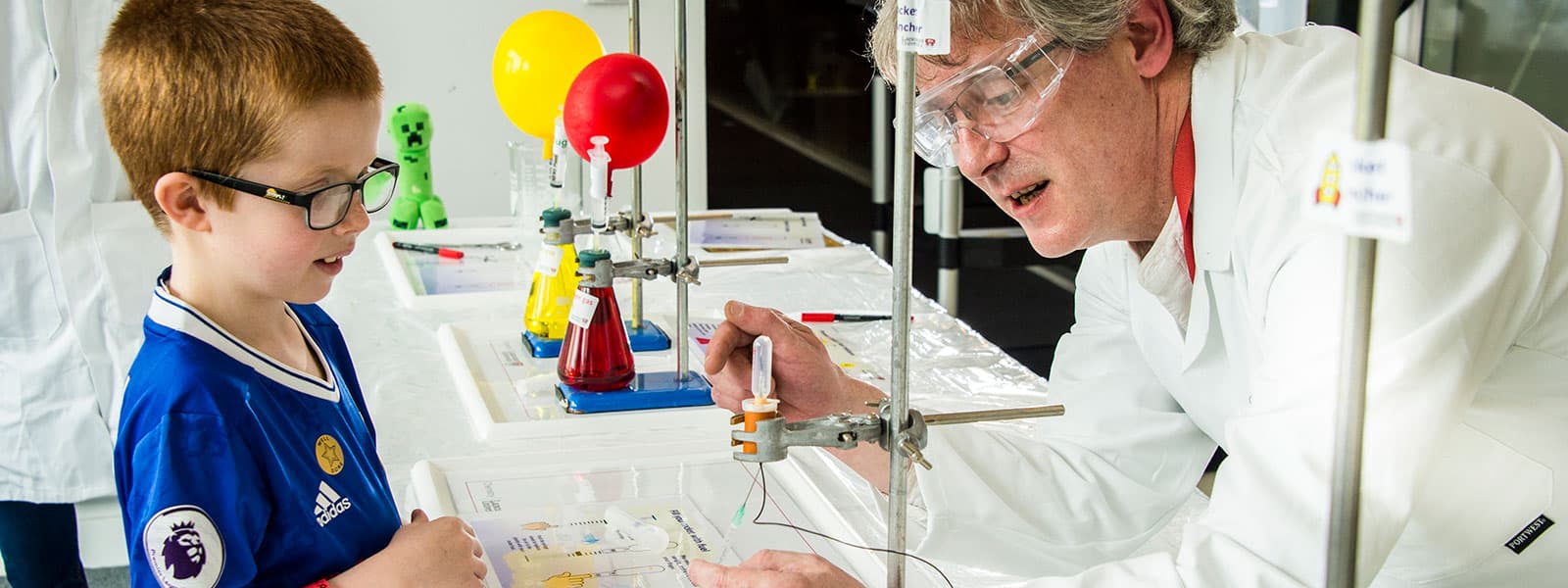 A young boy watched a science demonstration