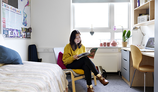 Girl reading in her bedroom.