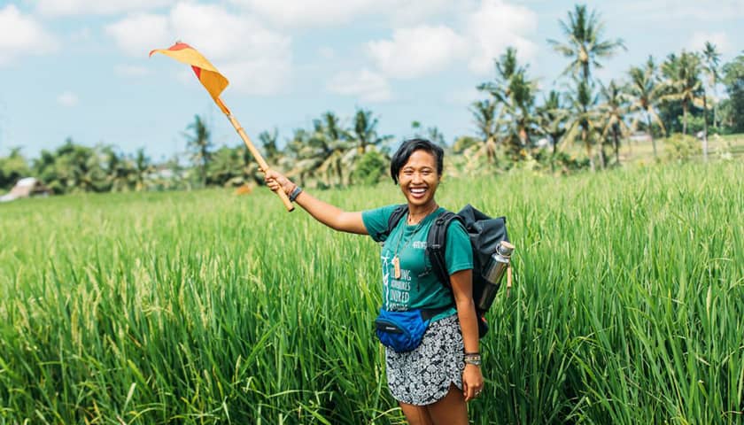 Student waving a flag in Bali