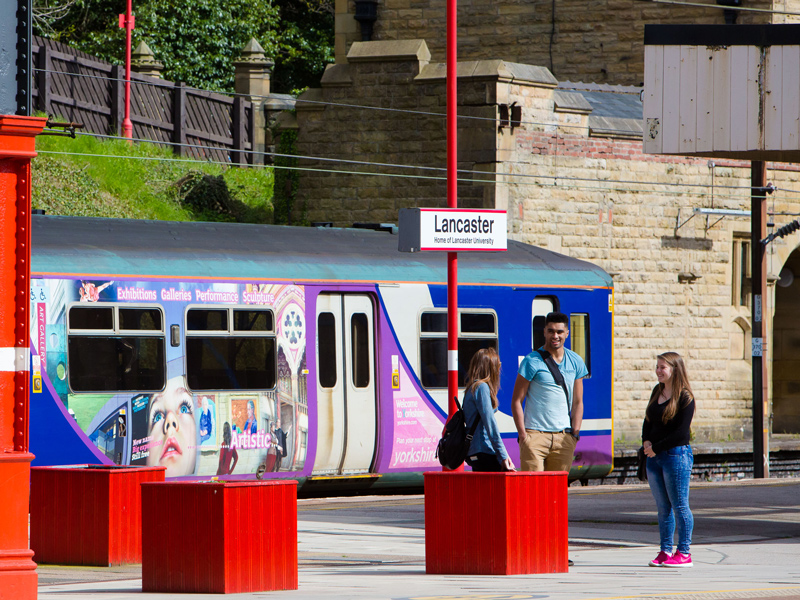 Three students at the Lancaster Train Station
