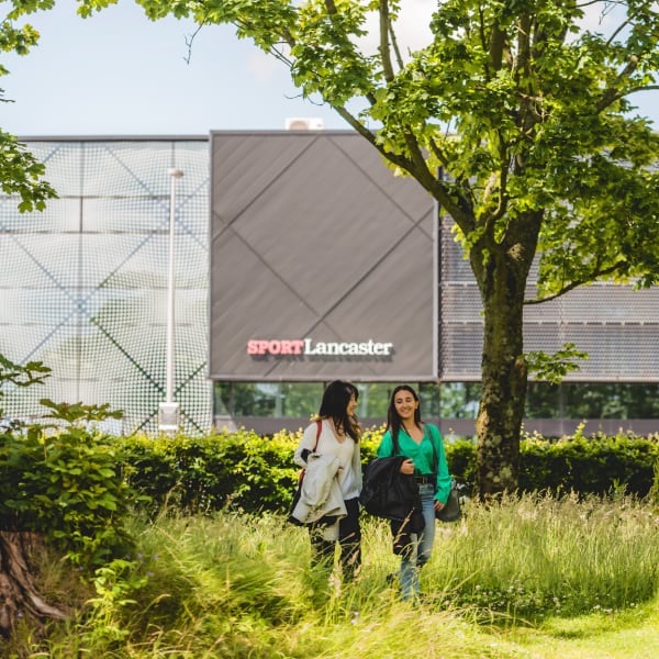 A group of students walking by the Sports Centre.