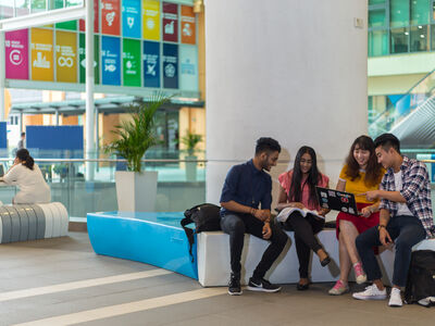 Sunway students looking at a laptop.