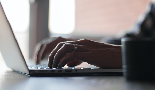 Hands on laptop keyboard