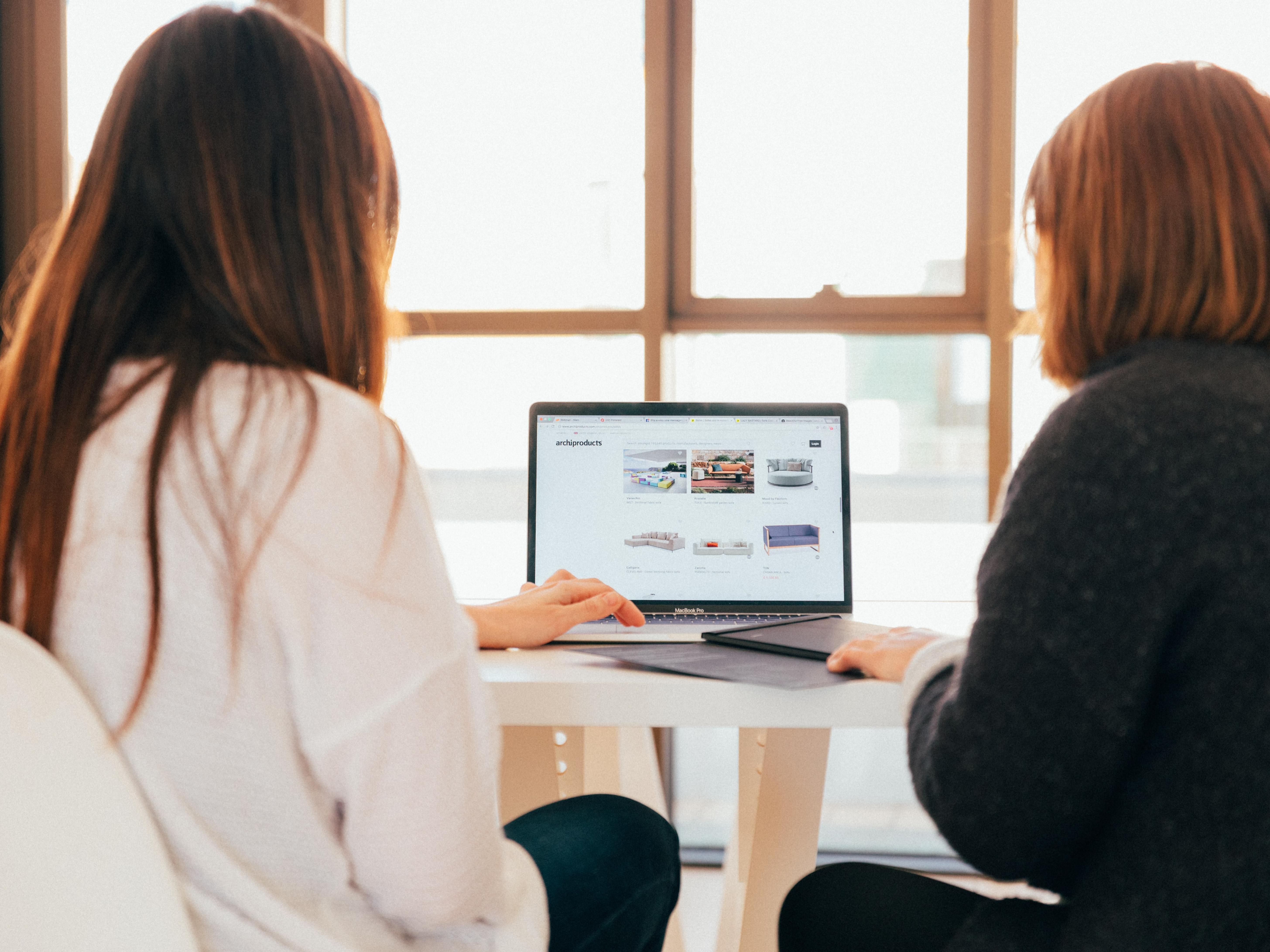 A woman writing notes on an iPad.