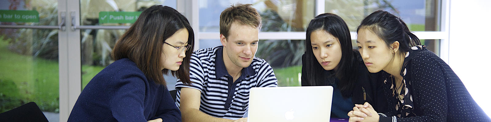 Group sitting around a laptop.