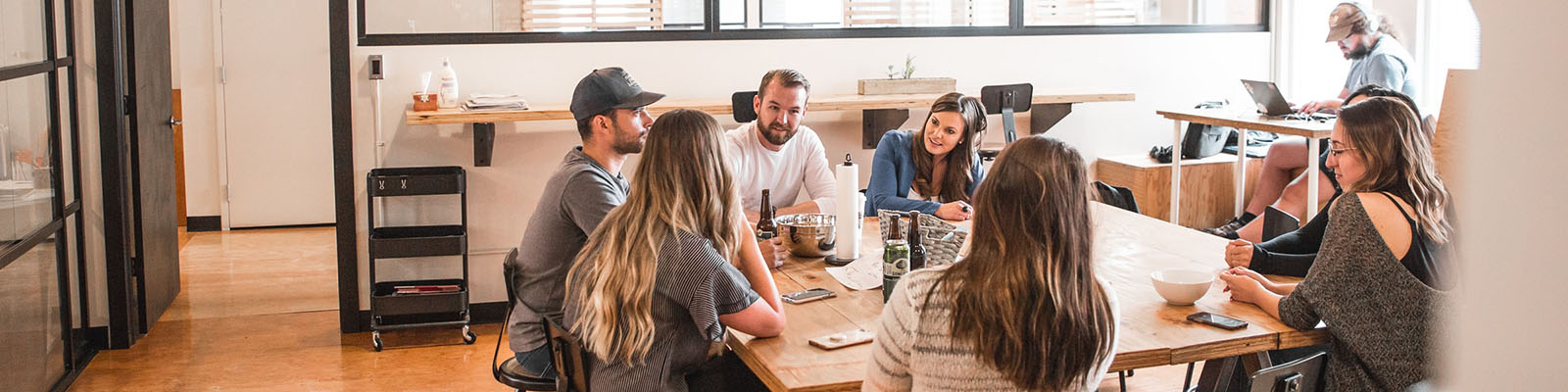 A group meeting around a wooden table.