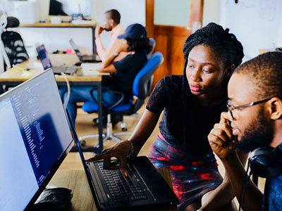Two people looking at a computer screen.