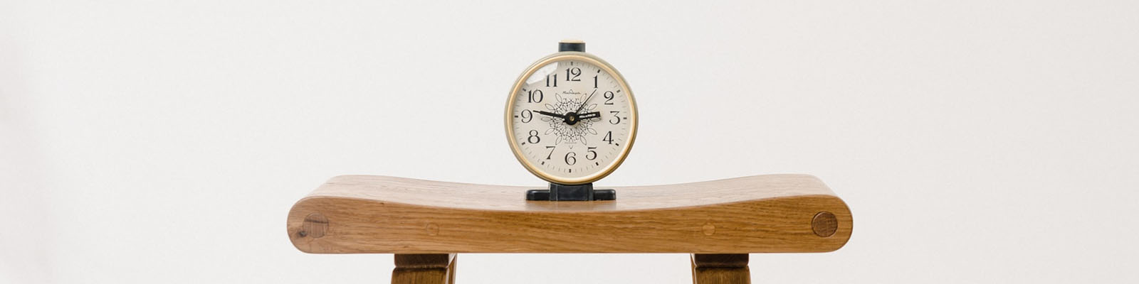 A clock on a shelf.