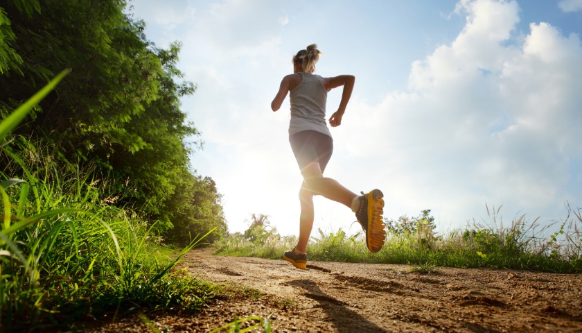 A person jogging along a country path.