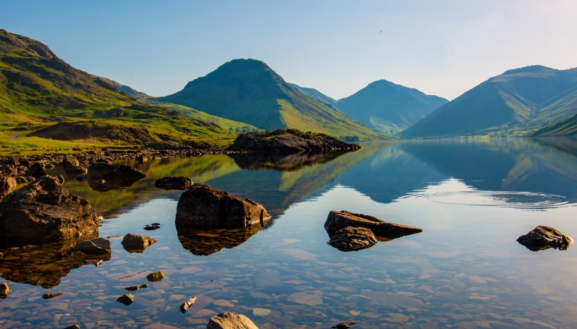 Mountains are reflected in the smooth waters of Wastwater.