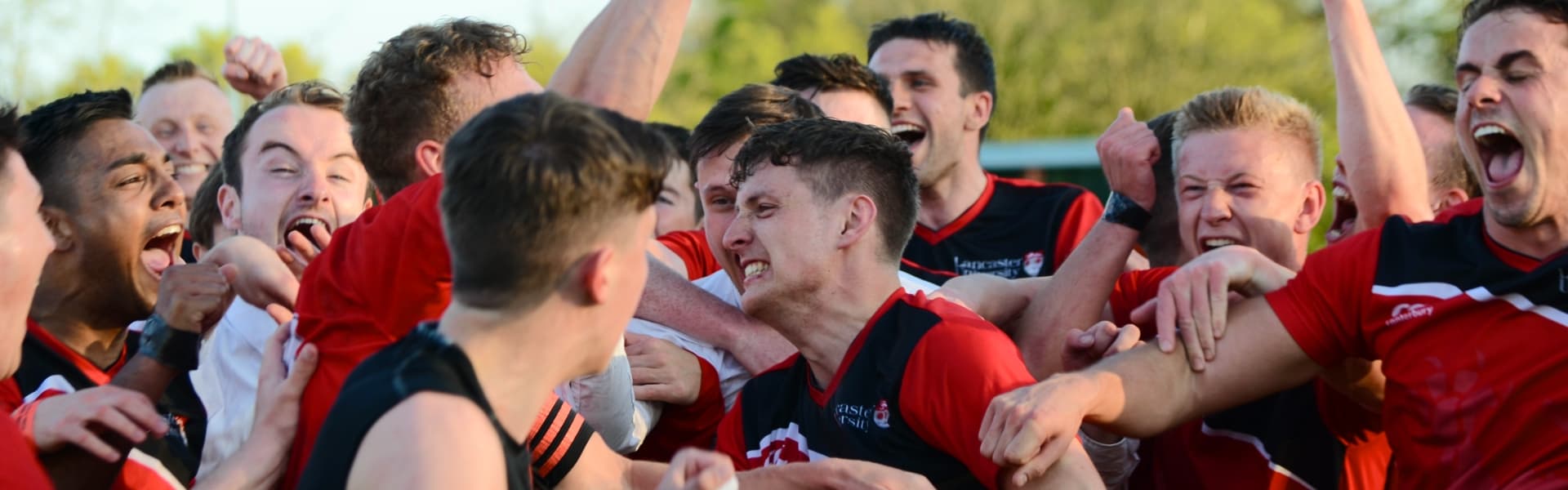 A team of male students celebrate victory in the Roses Tournament.