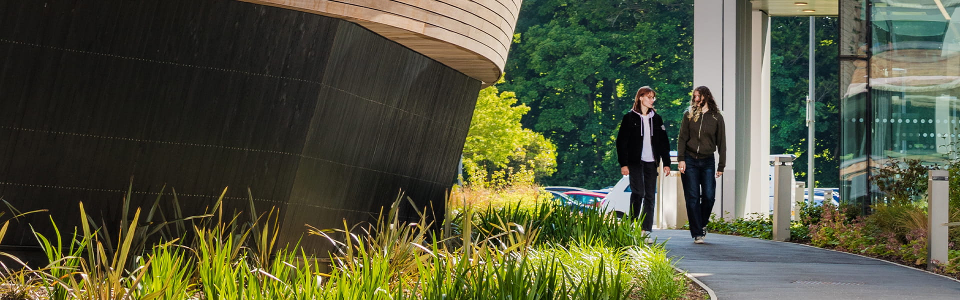 Two students walking beside the Chemistry Building