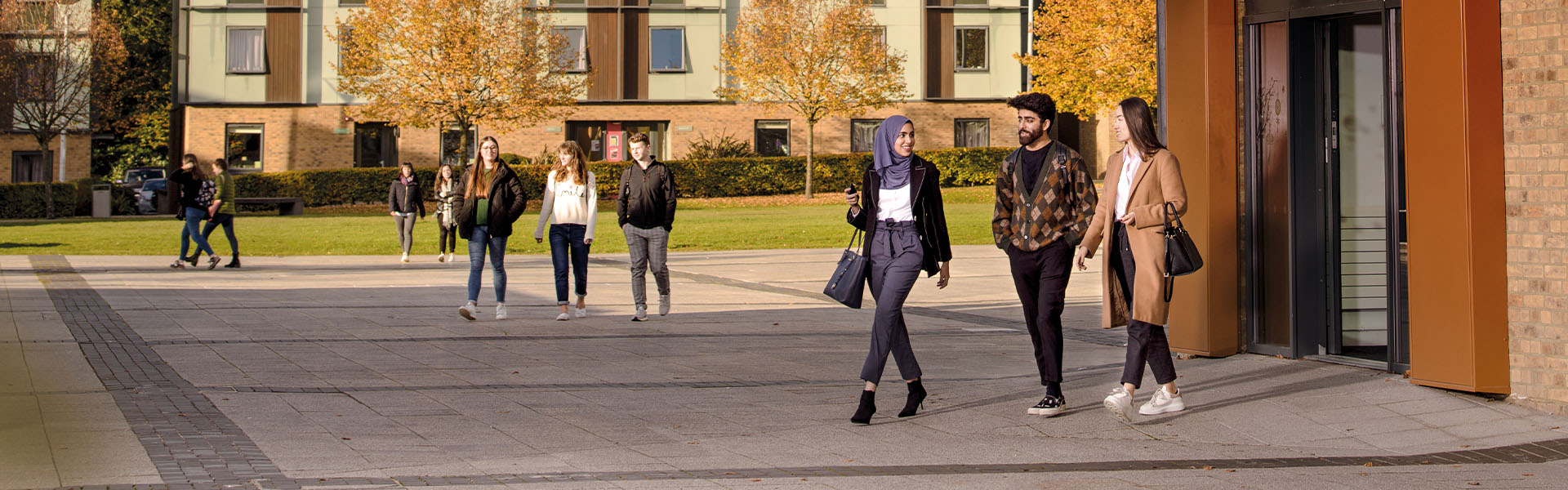 Students walk across Lancaster Square by the Confucius Centre.