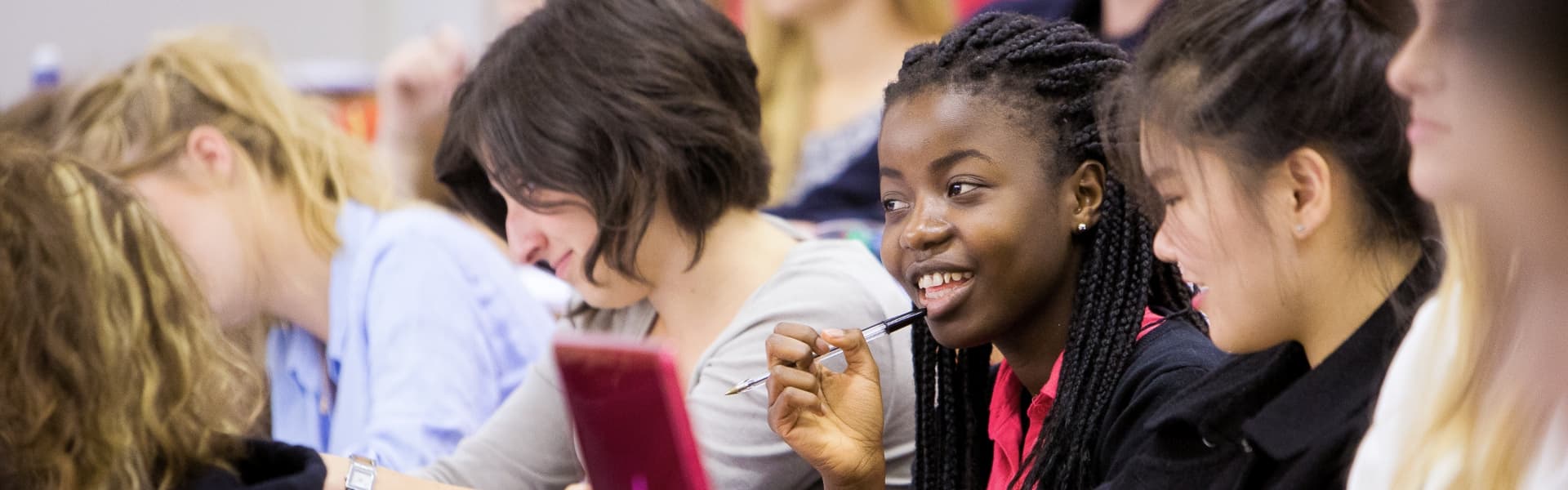 Students in a lecture theatre pay attention.