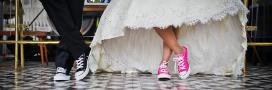 woman in wedding dress wearing pink shoes, man in suit wearing blue shoes on wedding day