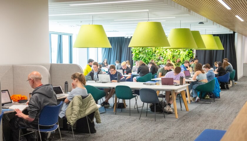 One of the library study areas with people studying at desks.