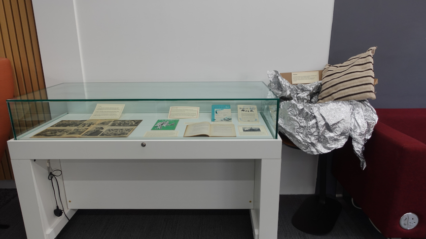 Exhibition featuring a cabinet with a stand containing a demonstration haybox