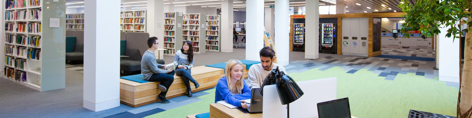 Library interior with students studying