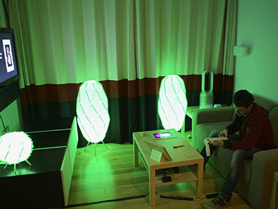 Man sitting in room lit by green light