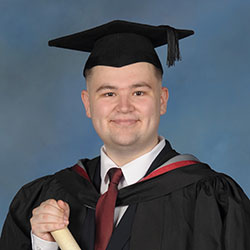 Alfie in his formal graduation photo in a cap and gown