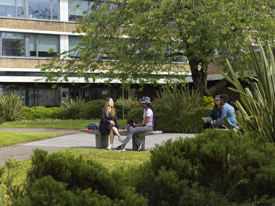 County Main Exterior, students on bench
