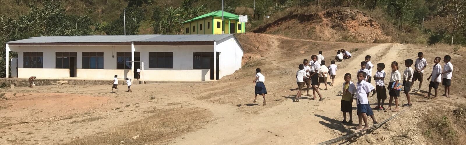 Children outside their community preschool in Timor Leste.