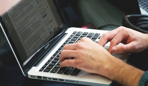 Person typing on laptop